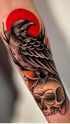 a bird sitting on top of a skull with a red sun in the back ground