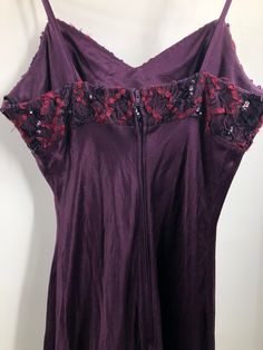 Vintage 1980's does 1930's deep plum purple slip dress. Crepe satin skirt with lace netting, ribbon, sequin and soutache bodice. Spaghetti straps. Zips up the back with hook and eye closure at top. Unstructured bodice. Bias cut with beautiful movement in the hem. Not lined. Made by De-Laru. Made in the USA. Dry clean only. Good vintage condition, some wear to the lace netting that's created a little pilling there. Otherwise no major issues. Purple Lace Trim Dress For Evening, Satin Slip, Dyed Dress, Satin Skirt, Satin Slip Dress, Coat Dress, Long Tops, Spaghetti Strap, Open Shoulder Tops