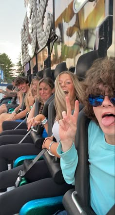 a group of people riding on the back of a roller coaster