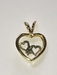 Beautifully vintage. Solid 14K Two Tone Gold Heart Charm Pendant. Stamped 14K and the designer's mark. Yellow Gold Heart with Double White Gold Hearts and a small, genuine, round cut Diamond. Can represent...Love, family, children, union, twins, siblings. Perfect for a necklace. Gold Double Heart 14k Stamped Jewelry, Collectible Yellow Gold Necklace With Heart Charm, Vintage Yellow Gold Heart Necklace For Valentine's Day, Gold Heart Cut Collectible Jewelry, Collectible Heart Cut Gold Jewelry, Antique Double Heart Jewelry For Anniversary, Antique Gold Heart Necklace For Anniversary, Collectible Gold Jewelry With Heart Charm, Collectible Gold Heart Pendant Jewelry