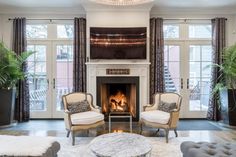 a living room filled with furniture and a fire place in the middle of a room