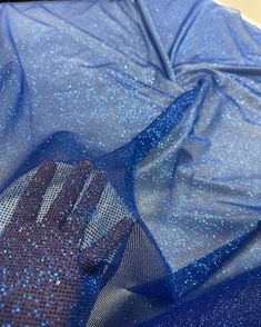 This is royal blue glitter on royal blue mesh/tulle. The fabric has shiny and sparkly look because of the glitter. The fabric serves multipurpose and can be used for dresses, gowns proms, decor, and many more.  PLEASE NOTE : Although there is no compromise with the quality of the fabric, some might notice falling off the GLITTER while handling, which is quite common with these kinds of fabric. CLR: Royal Blue WIDTH: 60/62 INCHES                   LENGTH : 36 INCHES (1 YARD) CONTENT/COMPOSITION: Crystal Fabric, Blue Sequin Fabric For Prom Season, Blue Sequin Fabric For Prom And Party Season, Glamorous Glitter Tulle Fabric For Evening, Glitter Tulle Fabric For Evening, Stretch Tulle Fabric For Party, Blue Sequin Fabric For Summer Evening, Evening Tulle Fabric With Glitter, Sequined Glitter Tulle Fabric For Party