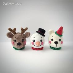 three crocheted animals wearing christmas hats