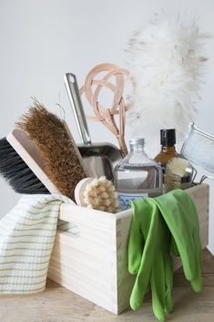 a wooden box filled with different types of cleaning products and scrubs on top of a table