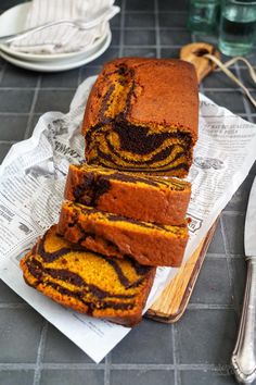 sliced loaf of cake sitting on top of a cutting board next to utensils