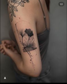 a woman's arm with a flower tattoo on it