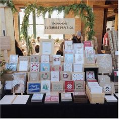 a table topped with lots of cards and boxes filled with christmas greetings on top of it