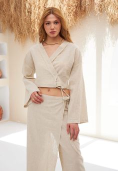 Discover our Women's Linen Wrap Set, a perfect blend of elegance and comfort. Featuring a premium linen wrap top and matching trousers, this set is designed for chic versatility. Experience relaxed sophistication and contemporary style with our breathable, fashion-forward linen duo. Shop now for your new wardrobe essential. Fitted Linen Wrap Top, Fitted Linen Wrap Top For Spring, Chic Fitted Linen Wrap Top, Spring Fitted Linen Wrap Top, Chic Linen Beach Sets, Chic Linen Sets For Beach, Chic Linen Vacation Set, Chic Linen Sets With Relaxed Fit, Wrap Trousers