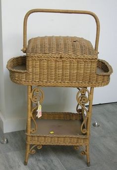 a wicker basket sitting on top of a wooden stand