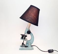 a microscope lamp with a black shade on it