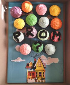 cupcakes are arranged in the shape of a house