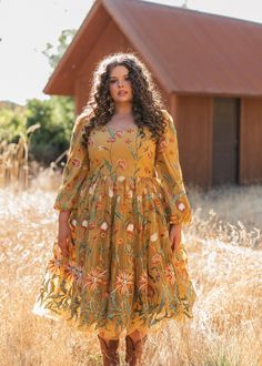 Golden Glow The Marigold Dress exudes a charming country chic aesthetic with its rich, mustard yellow hue and intricate floral embroidery. The dress features a flattering scoop neckline and long, sheer sleeves adorned with delicate botanical patterns. The voluminous skirt, with its layers of tulle, enhances the dress with a whimsical flair that beautifully captures the essence of rustic elegance and timeless style. Scoop neckline Back zipper Elastic full puff sleeve True to size Model Details Content + Care 100% Polyester Hand Wash Only Hang Dry Try-On Video Marigold Dress Try-On Video XS & XL Plus Size Dresses Modest, Plus Size Dress Sewing Patterns, Gold Floral Embroidery Dress For Spring, Mustard Yellow Dress, Yellow Plus Size Dresses, Marigold Dress, Mustard Yellow Dresses, What To Wear To A Wedding, Peasant Dress