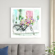 a painting of a bicycle with flowers on the front and back, hanging above a couch