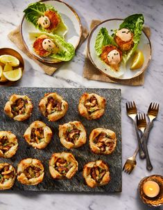 small appetizers are arranged on a table with silverware