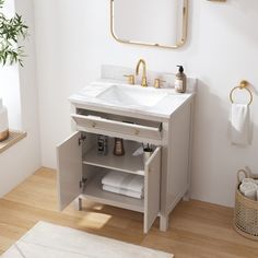 a bathroom with a sink, mirror and towel rack