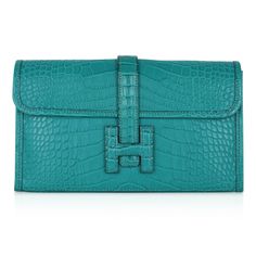 Guaranteed authentic Hermes Jige Duo Wallet featured in peacock Blue Paon Matte Alligator. This stunning Hermes Duo wallet also doubles as a clutch.Signature H with strap for closure.Two interior slot pockets. Removable change purse with four (4) credit card slots and a top zip.NEW or NEVER WORN.final saleWALLET MEASURES:LENGTH 7.9" WIDTH 4.9"CONDITION:NEW or NEVER WORN PLEASE NOTE: Hermes bag payments are bank wire transfer unless arrangements are made prior to purchase Hermes Jige, Alligator Wallet, Peacock Green, Hermes Handbags, Change Purse, Hermes Bags, Peacock Blue, Hermes Bag, Small Accessories