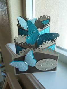 some blue and brown butterflies on a window sill