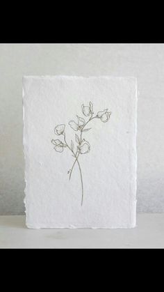 a drawing of flowers is shown on a piece of paper that has been drawn with ink