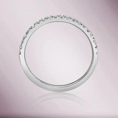 a white gold wedding ring with diamonds on the sides and an oval design in the middle