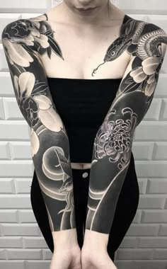 a woman with black and white tattoos on her arms