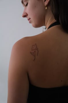 a woman with a small tattoo on her back