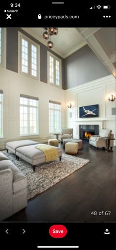 a living room filled with furniture and a fire place in the middle of a room