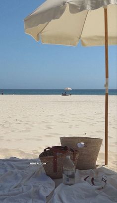 an umbrella and some bottles on the beach