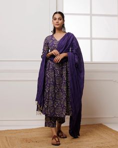 Add a touch of elegance to your wardrobe with our Violet Hand Block Printed Mul-Mul Suit Set. Made with high-quality mul-mul fabric and adorned with traditional Indian hand block printing, this striking violet suit set is perfect for any season. Complete the look with the matching dupatta for a stylish impact. No. of piece - 3 piece set. Color - Violet. Fabric - Mul-Mul. Washing Instructions - Dry Clean. Cotton Silk Kurta With Printed Motifs In Traditional Drape, Traditional Silk Palazzo Set With Bandhani Print, Traditional Slub Silk Palazzo Set With Printed Motifs, Traditional Silk Palazzo Set With Block Print, Designer Slub Silk Sets With Printed Motifs, Cotton Palazzo Set With Printed Motifs For Wedding, Elegant Bandhani Print Dupatta For Designer Wear, Elegant Designer Wear Dupatta With Bandhani Print, Eid Slub Silk Traditional Wear With Printed Motifs