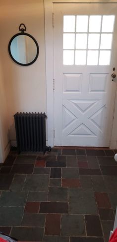 a room with a door, radiator and window