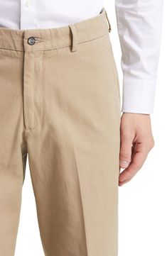 Tailored from soft cotton, these classic flat-front khakis feature a slightly relaxed fit and crisp creases running smartly down the legs. Zip fly with button closure Side-seam pockets; coin pocket 100% cotton Machine wash, tumble dry Imported Relaxed Fit Chinos With Welt Pockets For Business Casual, Elegant Beige Cotton Chinos, Classic Chinos With Pressed Crease For Work, Classic Fitted Beige Chinos, Classic Spring Chinos With Patch Pockets, Classic Tapered Leg Chinos For Work, Classic Relaxed Fit Chinos For Work, Classic Beige Chinos With Welt Pockets, Classic Solid Color Relaxed Fit Chinos