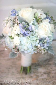 a bouquet of white and blue flowers is shown on the instagram page for this photo