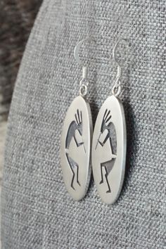 These Kokopelli sterling silver earrings are made by Hopi silversmith Timothy Mowa. The backs are signed and stamped sterling.Length: 1 3/4"Width: 5/8"Free shipping on all orders! We ship with USPS and always include tracking. All orders ship within a day of payment.Returns are accepted up to 30 days after you receive your order. Just send us a message. Our shop offers cash back or store credit. The item must be returned in new condition. Silver Symbolic Engraved Earrings, Engraved Teardrop Sterling Silver Earrings, Silver Engraved Symbolic Earrings, Symbolic Engraved Silver Earrings, Symbolic Silver Jewelry With Matching Earrings, Polished Sterling Silver Earrings, Engraved Sterling Silver Drop Earrings, Silver Southwestern Style Earrings For Gifting, Silver Southwestern Earrings For Gift