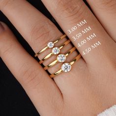 a woman's hand with three different rings on it and the size of each ring