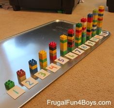 a metal tray filled with legos on top of a floor