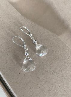 These clear Swarovski crystal teardrop earrings are dainty, minimalist, and elegant. Available in 14k gold-filled or sterling silver, they feature smooth metal beads and your choice of balled ear wires or lever backs. Perfect for everyday wear or gifting. The earrings measure just over 1.25" from end to end. The clear crystals are approximately 11x10mm. Please make your preferred metal selection from the drop down menu at check out. You may also like to check out more of my earrings here: http:/ Affordable Silver Beaded Crystal Earrings, Elegant Faceted Dangle Teardrop Earrings, Elegant Faceted Teardrop Dangle Earrings, Elegant Faceted Teardrop Earrings, Elegant Clear Drop Crystal Earrings, Elegant Clear Teardrop Crystal Earrings, Pearl Drop Teardrop Crystal Earrings, Nickel-free Teardrop Crystal Jewelry, Crystal Teardrop Earrings With Pearl Drop