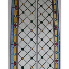 an old stained glass window with geometric designs