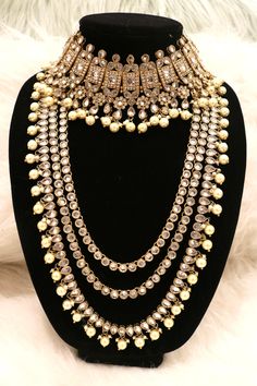 Handcrafted with love to give a real traditional look for this set beautifully studded with polki stones and pearls give a royal look. Includes: Choker, Rani Haar, Earrings, and Tikka Designer Hand Set Chandbali Jewelry, Elegant Pearl Jewelry With Meenakari, Elegant Meenakari Pearl Jewelry, Elegant Bridal Earrings With Stone Work And Pearl, Elegant Pearl Bridal Earrings With Stone Work, Gold Chandbali Bridal Necklace, Gold Chandbali Bridal Necklace For Designer Wear, Elegant Kundan Bridal Sets With Meenakari, Chandbali Stone Work Jewelry Sets For Designer Wear