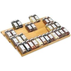 a wooden tray filled with lots of different kinds of condiments on top of each other