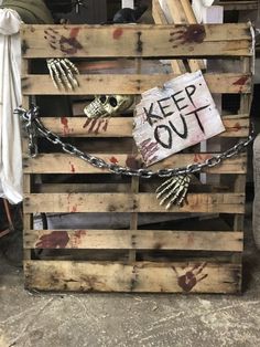 a wooden pallet that has been chained up with chains and skeleton hands on it