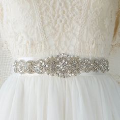 39.99 EUR Do you need a Crystal Bridal Sash Belt to complete your wedding look? This one would go great with MCC bridal barefoot sandals, so just add it to your cart :) Satin Bridal Sash Belt with Crystals and Pearls • 11,5'' x 2'' (29cm x 5cm) crystal motive • Shown on a 26'' (66cm) waist circumference mannequin • Silver or Rose Gold crystal's finish • 1,5'' (4cm) wide two sided satin ribbon in White or Ivory • 3 yards (2,75m) of ribbon, if you need other length, let me know in the… Silver Bridesmaid Sashes Bridal Accessories, White Bridal Accessories With Sashes, Bridal Sash Belt, Wedding Sash Belt, Satin Sash, Rose Gold Crystal, Rose Gold Bridal, Bridal Sash, Wedding Belts