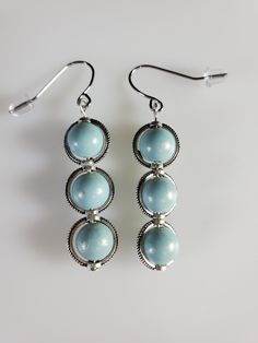 unique earrings. Blue frosted or faux pearl blue. Made in a smoke free, pet friendly environment. Elegant Light Blue Beaded Earrings As Gift, Elegant Blue Beaded Hypoallergenic Earrings, Elegant Blue Hypoallergenic Beaded Earrings, Elegant Light Blue Hypoallergenic Earrings, Elegant Light Blue Beaded Drop Earrings, Nickel Free Light Blue Metal Earrings, Elegant Light Blue Beaded Earrings, Elegant Light Blue Round Beaded Earrings, Hypoallergenic Light Blue Drop Earrings