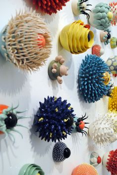 an assortment of colorful objects are displayed on a wall