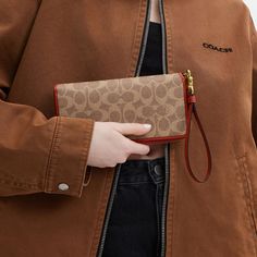 A timeless style made modern with a detachable wrist strap this Signature canvas and refined leather wallet has a continental zip-around closure and an elongated shape. The organized design has extra room for a phone receipts gift cards and small essentials making it the perfect wallet for everyday. | Coach Essential Continental Wallet In Signature Canvas - Women's - Brass/tan/rust Modern Coach Wallet For Daily Use, Coach Rectangular Travel Wallet, Coach Travel Wallets Rectangular, Coach Rectangular Wallet For Travel, Coach Travel Wallet, Rectangular, Modern Coach Wallets, Coach Travel Wallet With Zipper Closure, Coach Travel Wallets With Zipper Closure, Coach Wallets With Zipper Closure For Travel