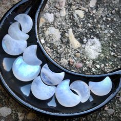 a black and white plate with several pieces of glass on it sitting on the ground