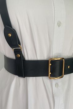 Made of genuine full grain leather, with beautiful black edges and black back.  Gold-colored hardware with a double prong bucket and collar pin. This beautifully made harness allowed for the easiest wardrobe update. 
Wear this classic black belt with or without the harness to define your look. Layer with the harness over dresses, tops, sweaters and suits for an edgy and modern look. Made for "The True Size Majority" sizes 10-22 by BAACAL Cynthia Vincent. Faux Leather Harness Belt, Leather Harness Women Costumes, Harness Belt Blazer, Harness Belt And Dress, Hip Leather Belt, Leather Suspenders For Women, Chest Harness With Dress, Black Belts For Dresses, Elegant Luxury Black Belts And Suspenders