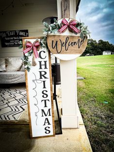 a welcome christmas sign on the front porch