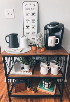 a coffee bar with cups and mugs on the shelf next to it is also a sign