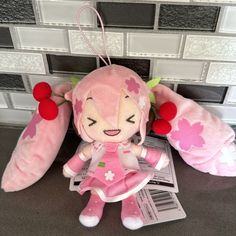 a pink stuffed animal sitting on top of a table