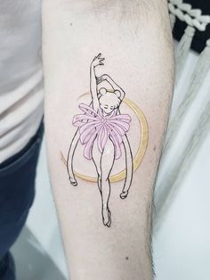 a person with a tattoo on their arm that has a drawing of a ballerina