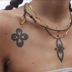 a woman's chest with tattoos on it